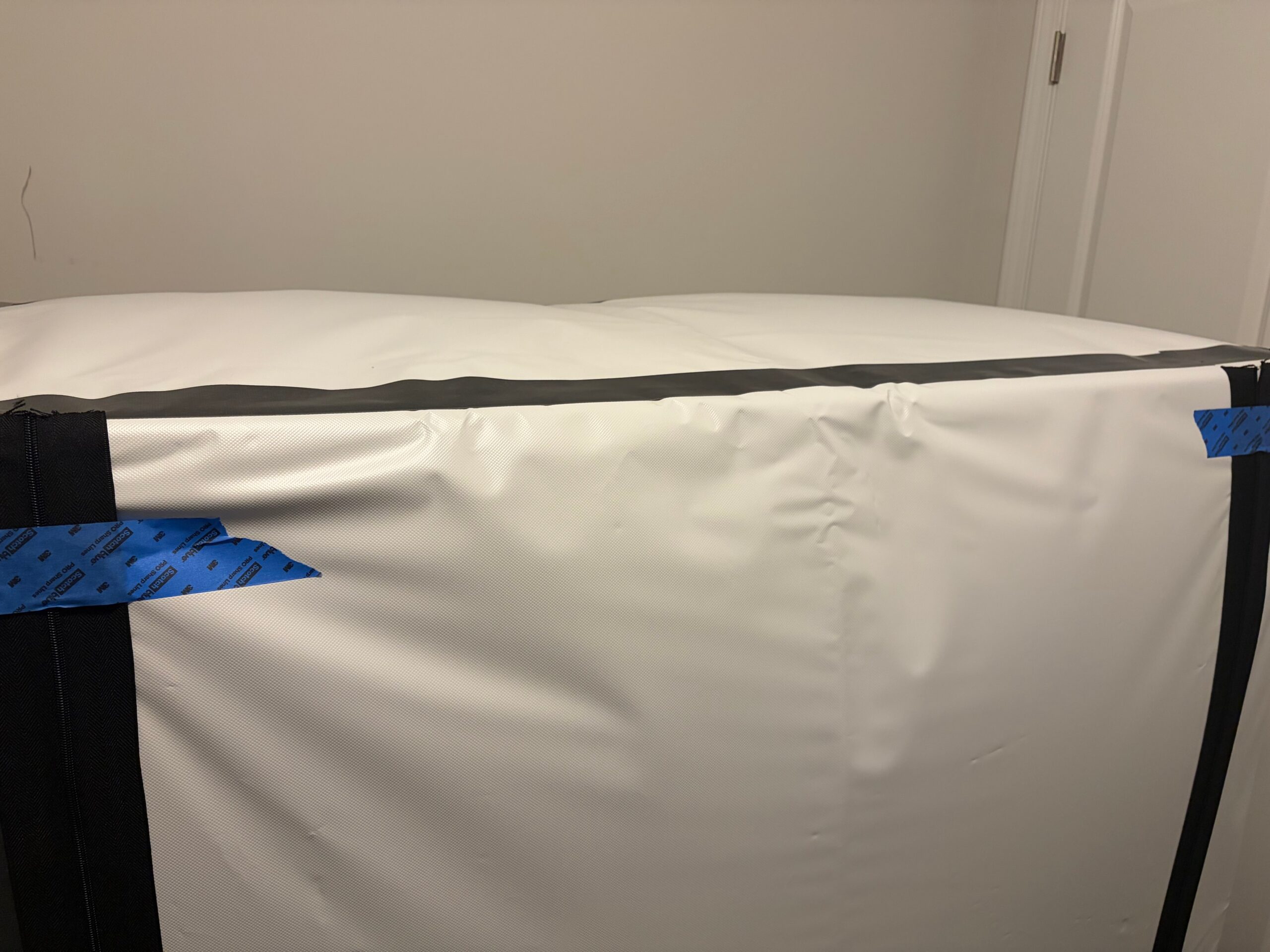 Homemade grow tent with bulging sides showing positive pressure.